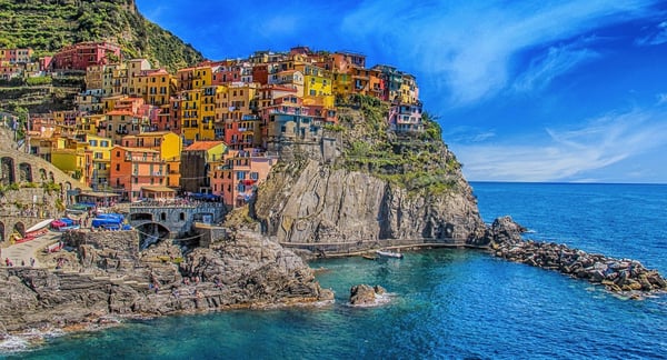 Colourful homes set against the Riomaggiore cliffside in italy