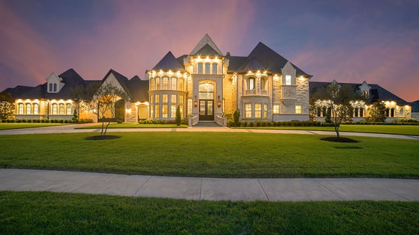 Beautifully lit exterior of a luxury mansion